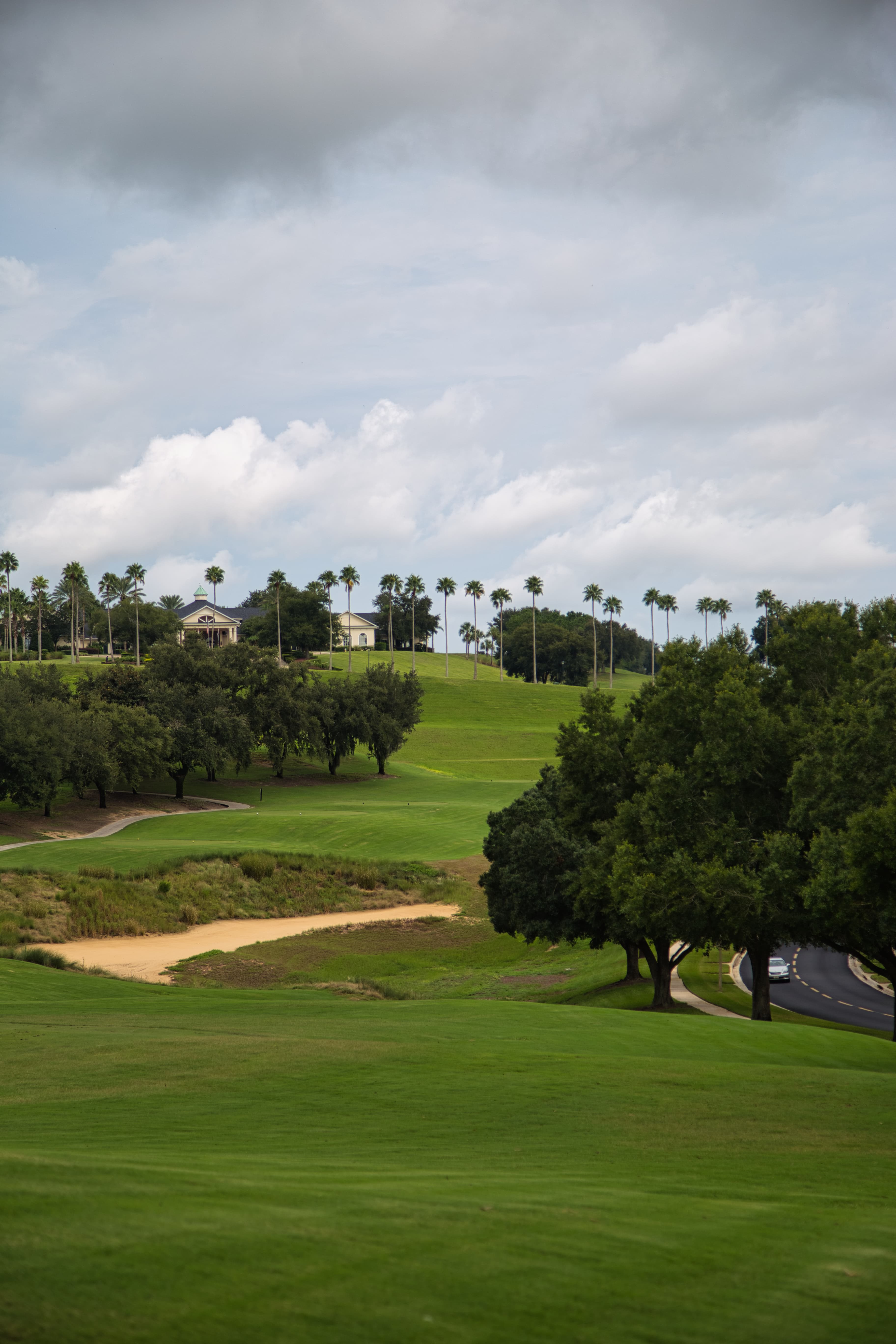 Elevated fairway view with palm trees and the Clermont National clubhouse