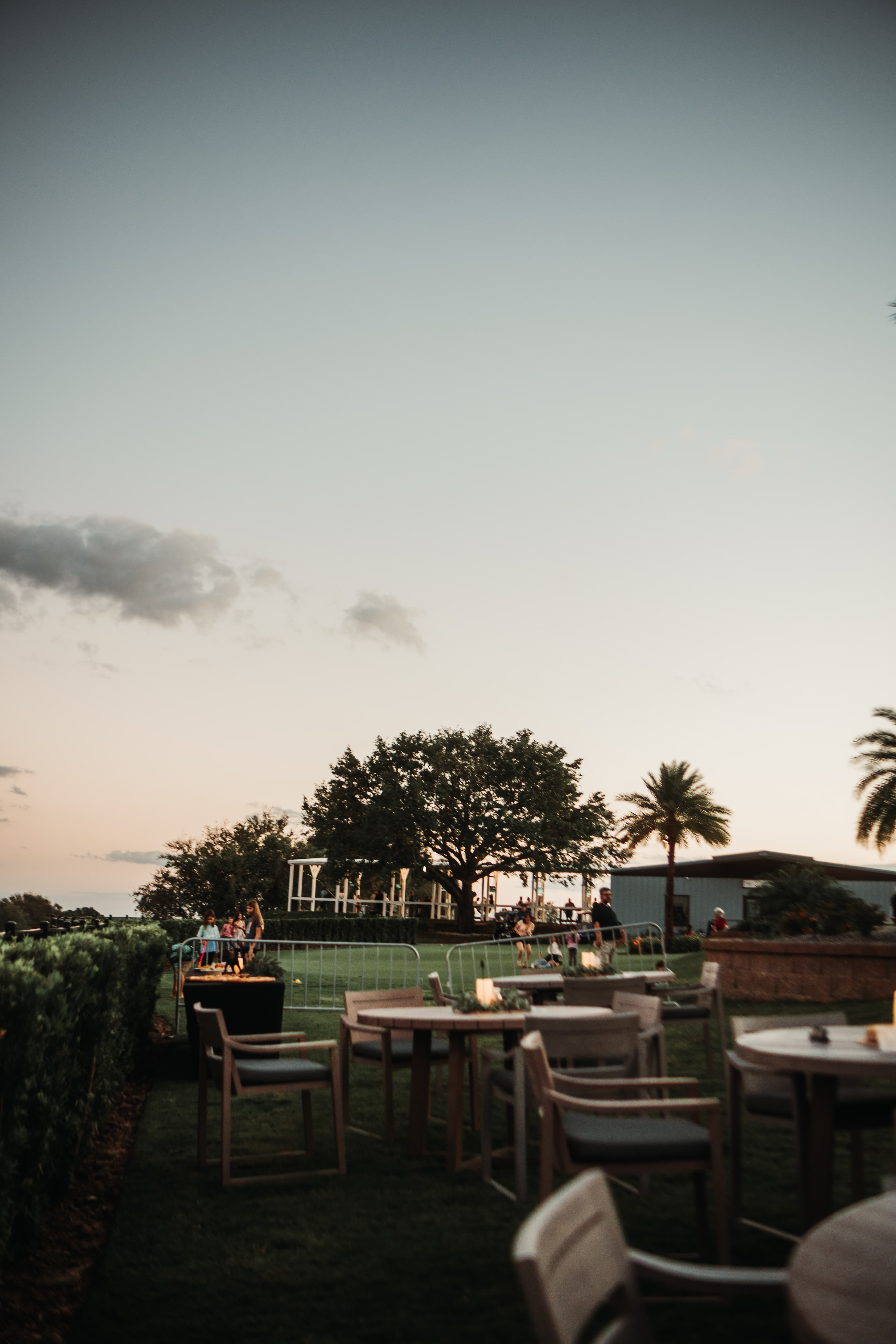 Outdoor patio dining at sunset with guests enjoying the view